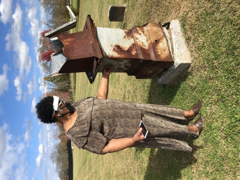 Mary Watkins, President of the African American Heritage Society of Rutherford County stands near the center of section M in Evergreen Cemetery.