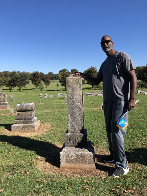 Daryl Webb stands at his ancestor's grave.